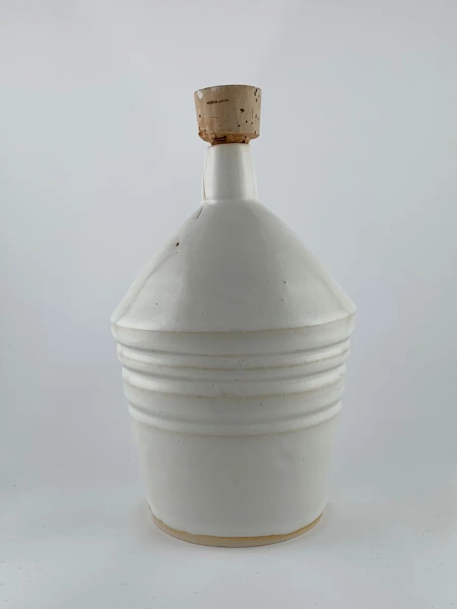 White glazed ceramic bottle with cork stopper