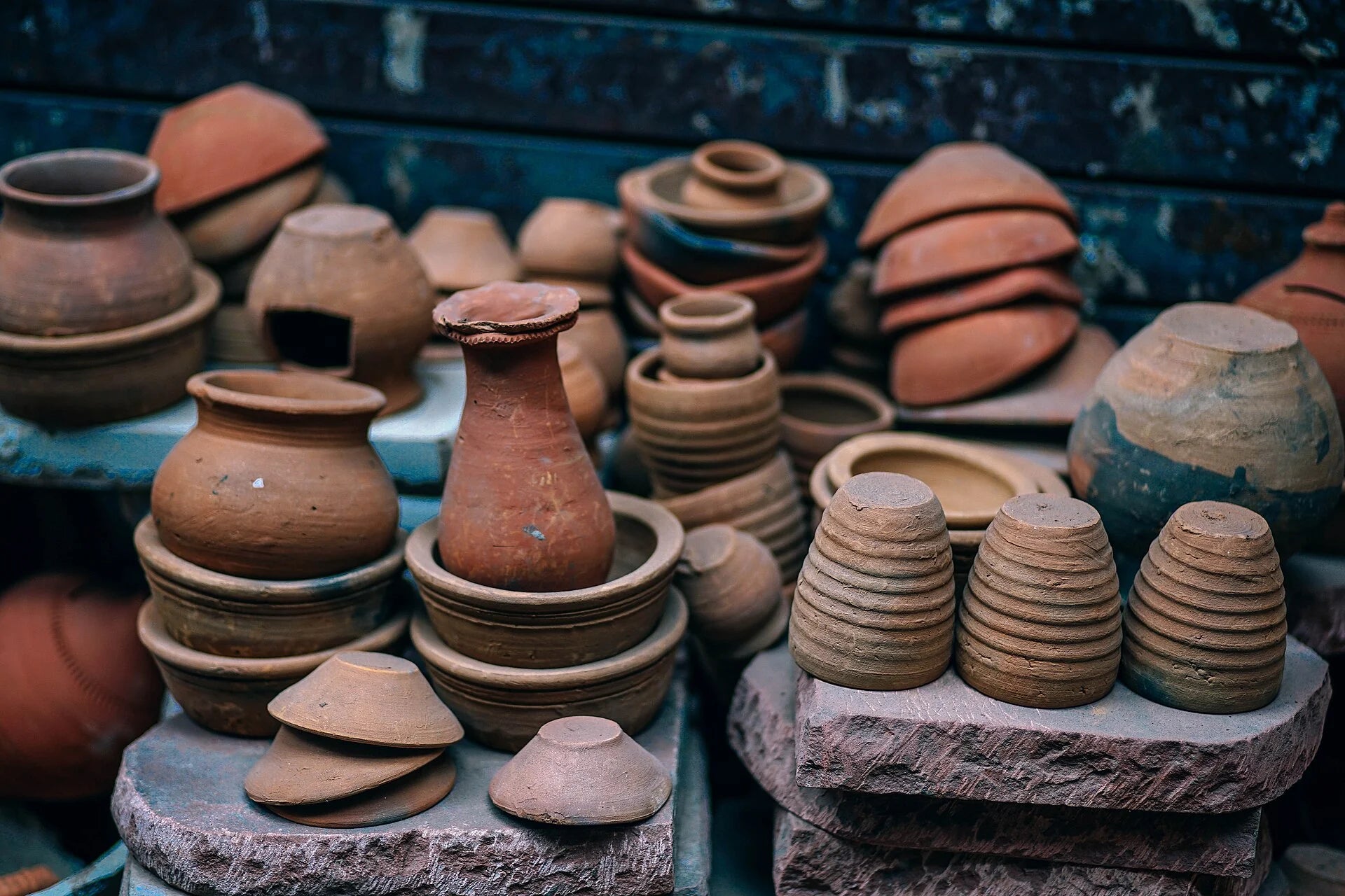 Assorted handmade terracotta pottery displayed in a workshop